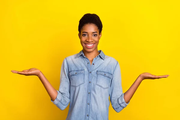 stock image Portrait of cheerful person arms palms demonstrate empty space vs scales isolated on yellow color background.