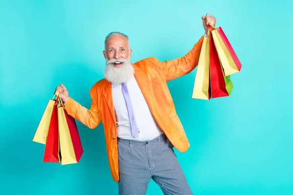 stock image Photo of excited funky granddad hands hold shop bags rejoice isolated on turquoise color background.