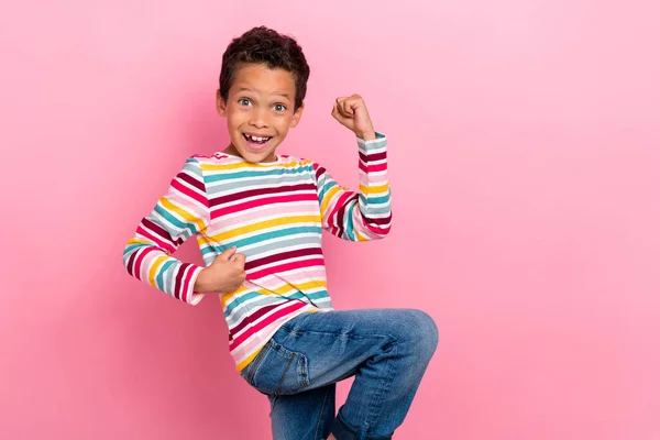 興奮したラテン語の小さな男の子の写真はピンクの色の背景に隔離された流行の縞模様の外観を身に着けている拳悲鳴Hoorayチャンピオンを上げる — ストック写真
