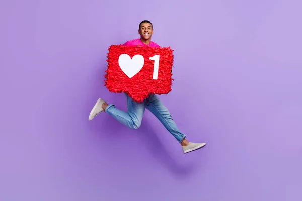 stock image Full size photo of overjoyed excited man jumping arms hold large like collage isolated on violet color background.