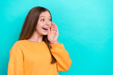 Profile photo of excited teen girl wear orange sweatshirt touch cheeks palm announcement black friday look mockup isolated on cyan color background. clipart