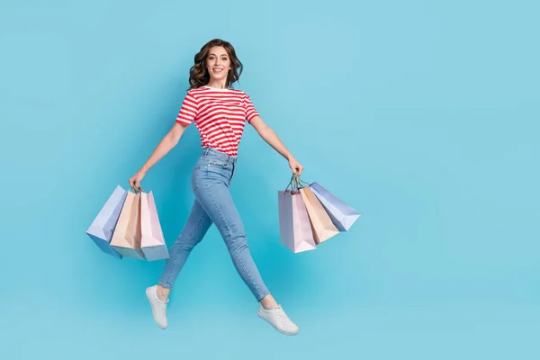 stock image Full length photo of graceful lady client customer go walk empty space carry deliver stylish clothes isolated on blue color background.