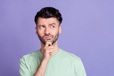 Close up photo of intelligent minded man look empty space finger touch chin consider plan idea question isolated on purple color background. clipart