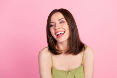 Photo of cheerful positive attractive girl with bob hairdo wear khaki top smiling looking at camera isolated on pink color background.