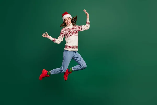 stock image Full body photo of energetic overjoyed lady jumping flight empty space isolated on green color background.