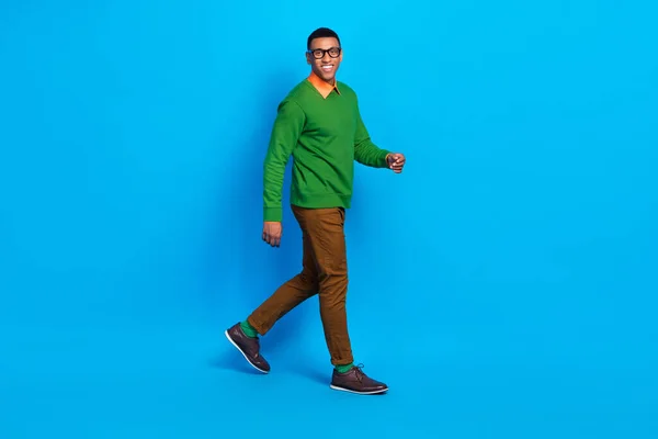 Full size profile photo of young satisfied positive guy wear nice shoes classy gentleman outfit walking his office isolated on bright blue color background.