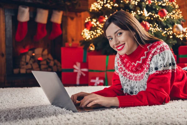 stock image Photo of cheerful attractive lady lying fluffy carpet use gadget netbook enjoy winter magic cozy evening house indoors near fireplace.