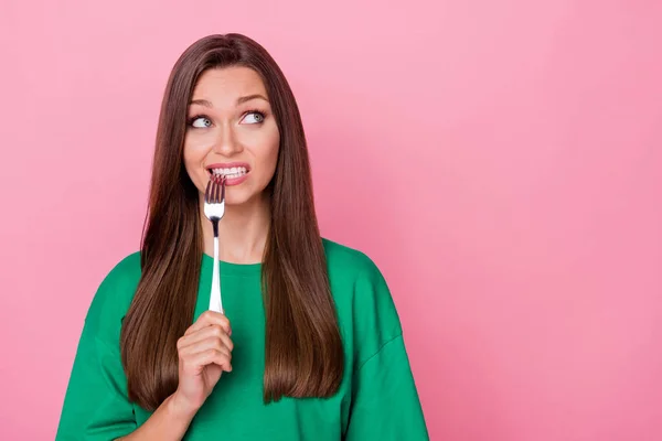 stock image Portrait of positive gorgeous thoughtful girl with straight hairdo biting fork look empty space isolated on pink color background.