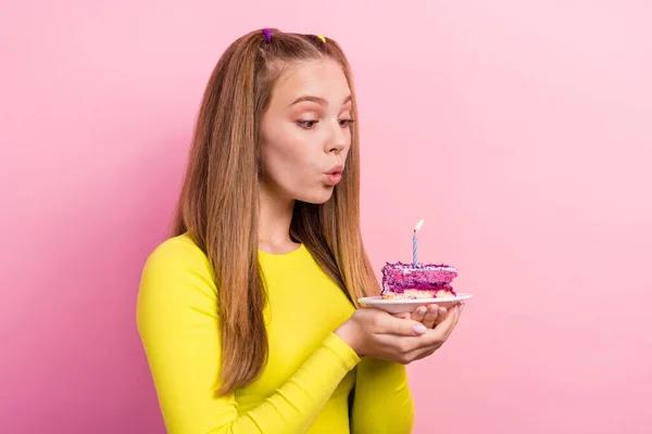 stock image Photo of shiny dreamy schoolgirl wear yellow top holding cake piece plate having birthday wish isolated pink color background.