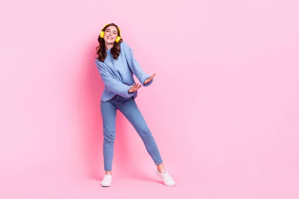 Full size portrait of overjoyed crazy girl enjoy dancing new single playlist isolated on pink color background.