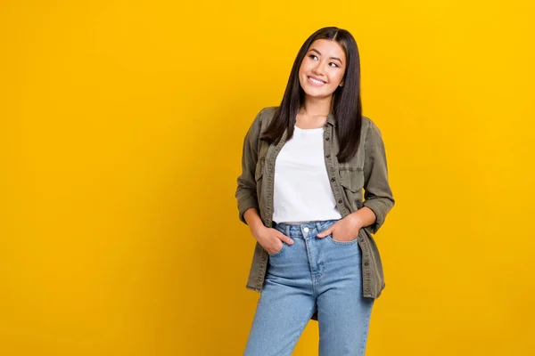 stock image Photo of gorgeous glad woman straight hairdo dressed gray shirt hands in pockets look empty space isolated on yellow color background.