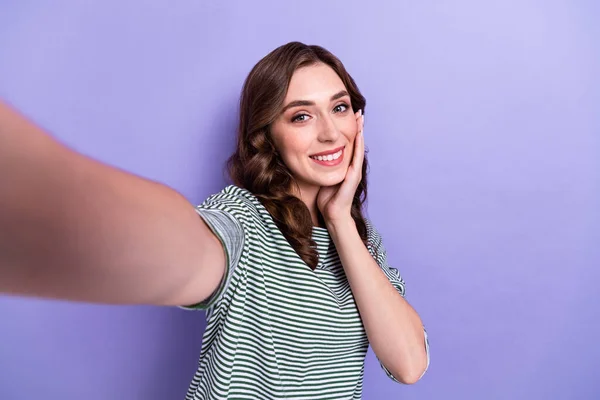 Photo of pretty cute shy modest lady wear trendy clothes arm touch face streaming showing empty space isolated on purple color background.