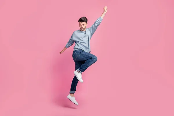 Full body size photo of young handsome attractive serious grimace man hand up look you confident superhero fly home isolated on pink color background.