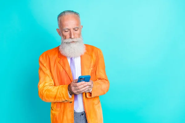 stock image Photo of successful serious granddad hold use telephone write typing empty space isolated on teal color background.