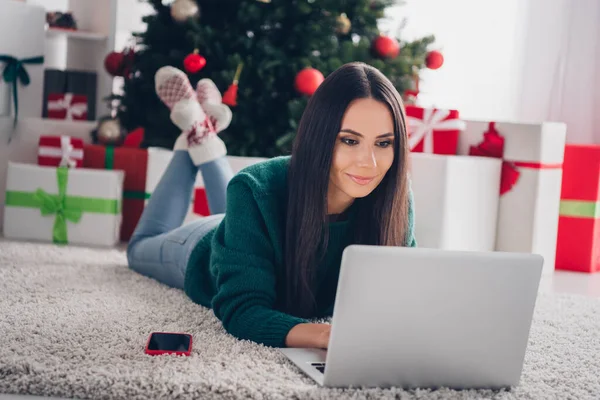 Photo of concentrated focused lady choose presents write sms message email greetings enjoy weekend magic day season house indoors.