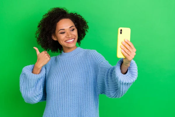 Photo of adorable funky girl with brunette hair dressed blue pullover doing selfie showing like isolated on green color background.