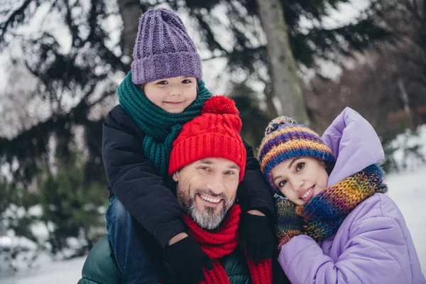 stock image Portrait of three peaceful positive people embrace toothy smile walking snowy forest outside.