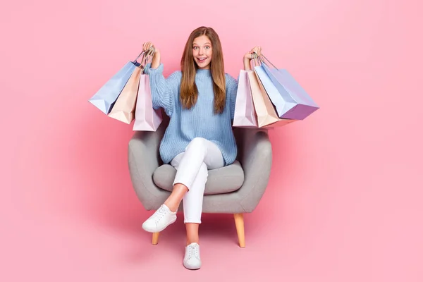 stock image Full body size photo of teenager wear blue knitwear jumper hold stack bargains celebrate black friday big sale isolated on pink color background.