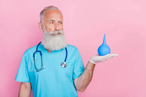 Photo of retired doc man hold blue douche medical equipment for cure isolated on pastel color background.