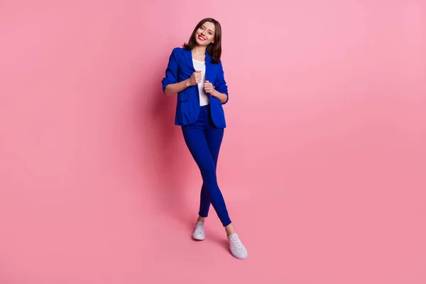 Full body size photo of experienced attractive positive smile lady wear blue formalwear suit fix her jacket boss isolated on pink color background.