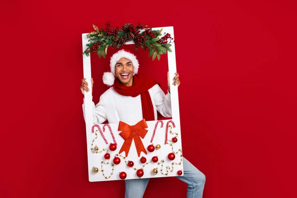 Portrait of cheerful excited person have good mood hands hold paper album card booth isolated on red color background.