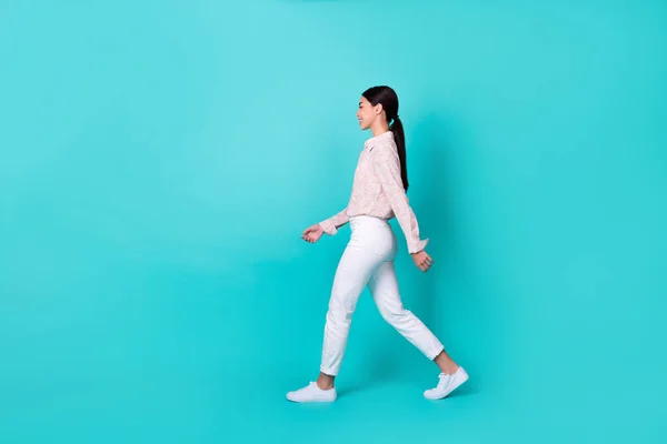 Full body profile photo of young japanese woman walking clothes promo wear trendy smart casual look isolated on aquamarine color background.