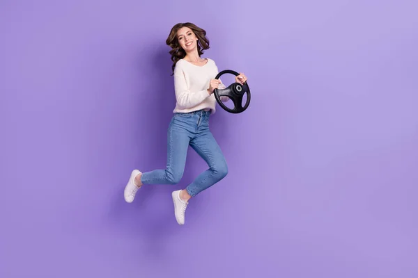 Full length photo of overjoyed lady jumping empty space rejoice buy new car first drive lesson course isolated on purple color background.