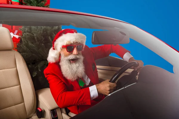 Photo of cheerful santa clause enjoy driving car road traffic hurry sunglass isolated over grey color background.