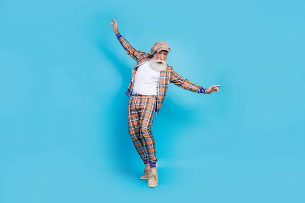 Full length photo of astonished man wear plaid stylish suit move tiptoes crazy birthday entertainment isolated on blue color background.