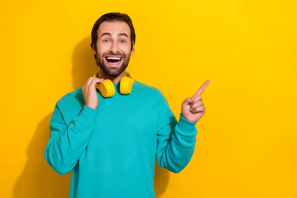 Photo Impressed Funny Man Wear Turquoise Clothes Headphones Pointing Empty — Stok fotoğraf