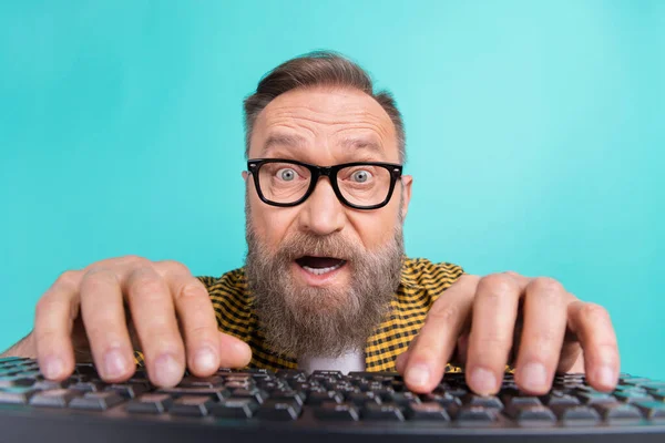 Photo of surprised shocked man web designer wear plaid clothes writing website 404 error feel young isolated on cyan color background.