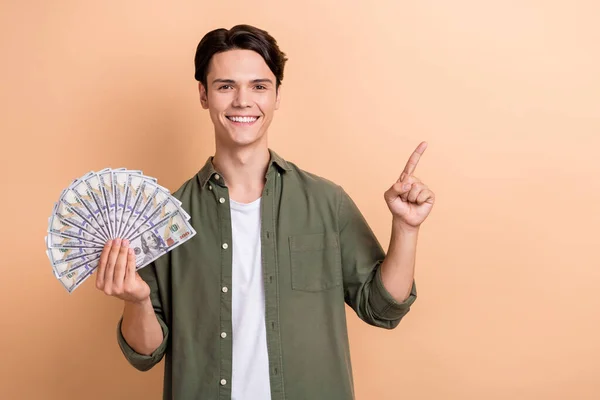 Photo Satisfied Positive Young Man Hold Dollar Bills Indicate Finger — Photo