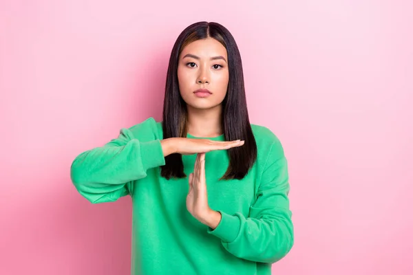 Photo of confident serious lady wear green sweatshirt showing arms palms time out sign isolated pink color background.