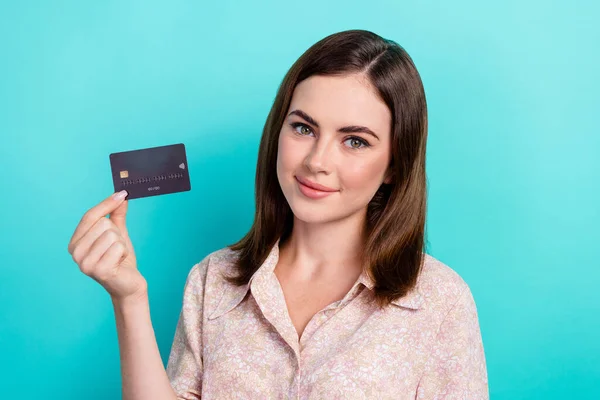 Stock image Photo of good mood sweet girl dressed pink shirt rising black debit card isolated teal color background.