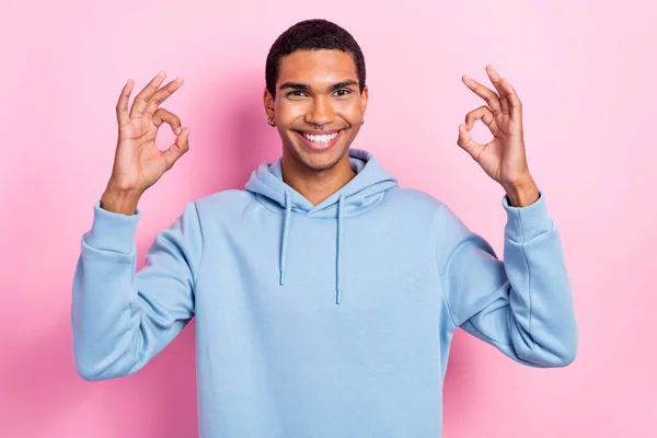 フレンドリーな男の写真歯の笑顔腕の指はピンクの色の背景に隔離されたキーシンボルを示しています — ストック写真