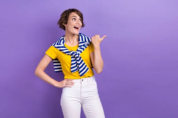 Photo of funky excited lady dressed tied jumper looking showing thumb empty space isolated violet color background.