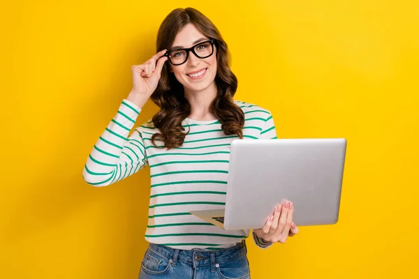 Photo of confident satisfied business management worker optimistic woman hold laptop touch glasses remote job isolated on yellow color background.