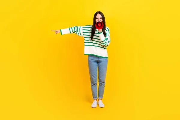 Full length photo of furious mad lady chief wear stylish striped clothes give command empty space isolated on yellow color background.