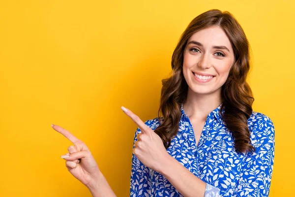 Closeup portrait photo of young promoter business lady wear formal blue blouse direct fingers empty space new ad isolated on yellow color background.