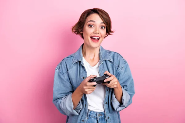 Photo of sweet excited lady dressed denim jacket enjoying playstation game isolated pink color background.