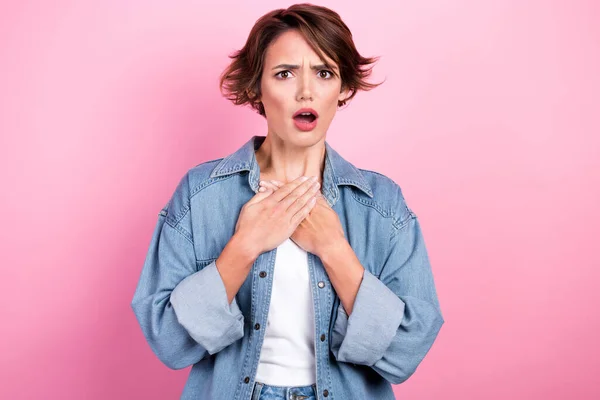 Photo of unhappy scared man hands folded chest open mouth dissatisfied panic nervous scared wear denim shirt isolated on pink color background.