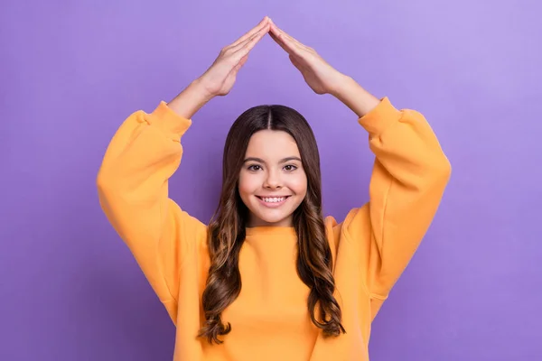 Photo of cheerful cute lovely lady wear stylish orange clothes hold arms under head isolated on purple color background.