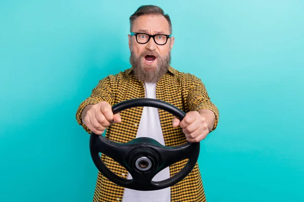 Photo of funny reaction scared taxi driver surprised car accident hold steering wheel open mouth speechless isolated on aquamarine color background.