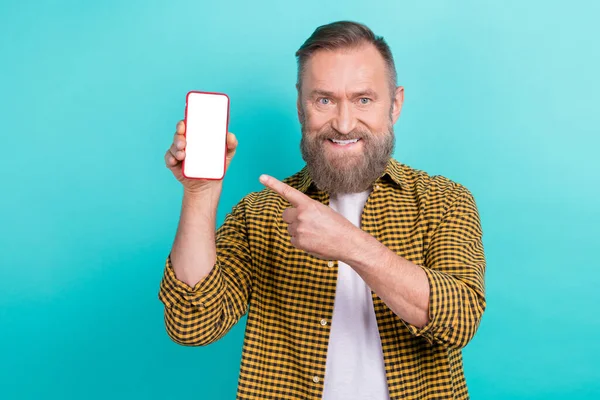Photo of nice glad retired man wear trendy clothes demonstrate telephone display qr code isolated on cyan color background.