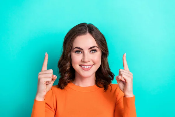 Closeup photo of young positive girl wavy hair smiling directing fingers up good news information promoter isolated on aquamarine color background.