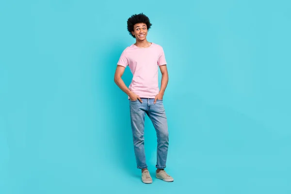 Full body size photo of young model smiling man wear stylish casual look hands pockets mass market advert isolated on aquamarine color background.