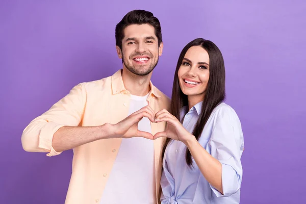 Photo of romance on job concept young students working together show fingers love symbol happy relationship isolated on violet color background.