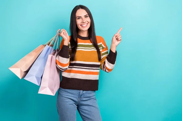 Photo Shiny Charming Woman Wear Striped Sweater Holding Shoppers Pointing — Φωτογραφία Αρχείου