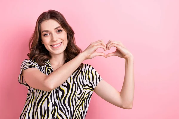 Photo of young good mood brown curly hair lady showing fingers sympathy heart symbol romantic valentine day isolated on pink color background.