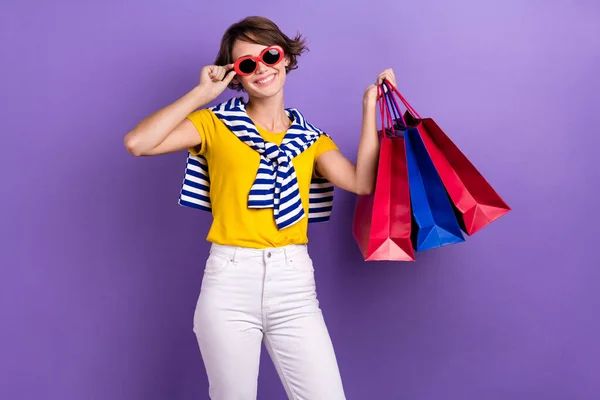 Photo of positive lovely lady wear yellow trendy summer clothes hold packs nice shopping isolated on purple color background.